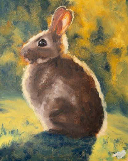 Painting of a rabbit sitting on grass with a blurred natural background
